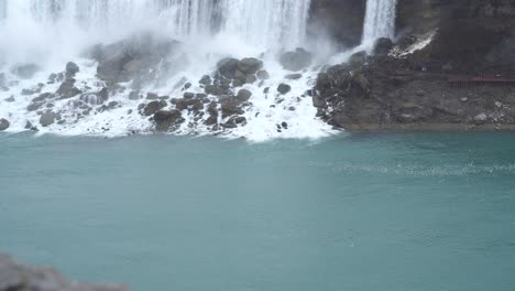 A-massive-flock-of-birds-congregating-behind-a-majestic-waterfall