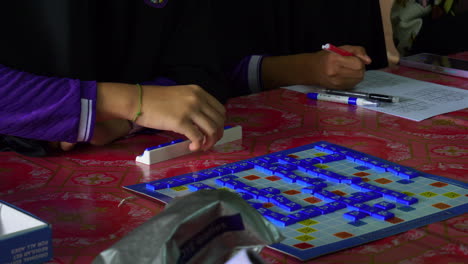 kids learning math by collared board game in muslim school