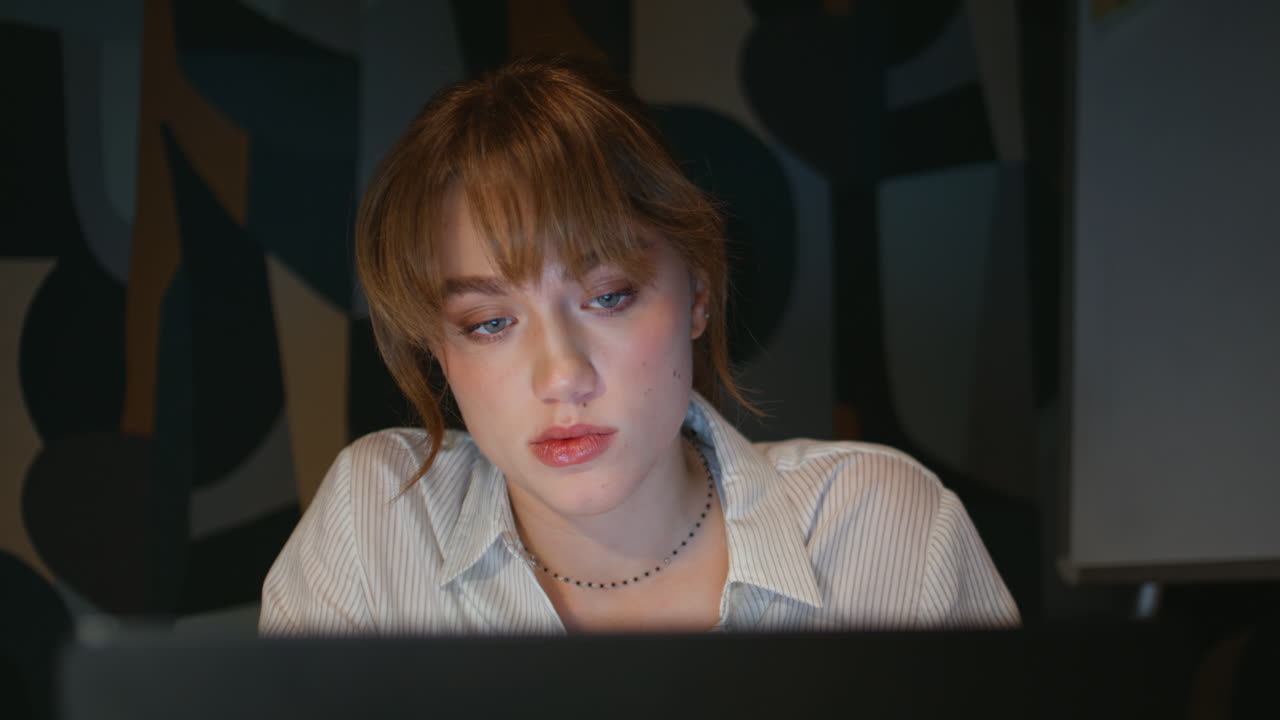 Late businesswoman face looking laptop night cabinet closeup. Overworked woman