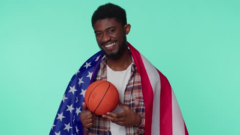 bearded young man basketball fan holding american usa flag doing winner gesture, dancing alone