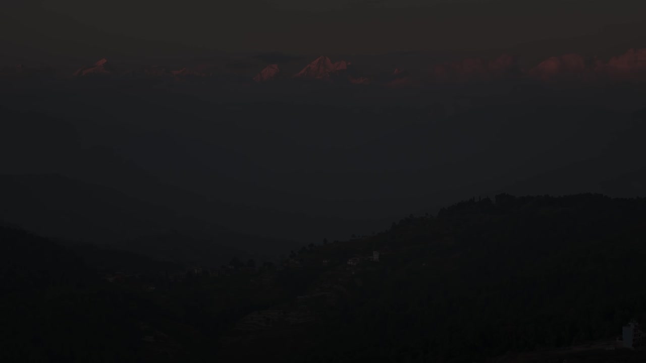 Aerial night drone footage of Nagarkot, Nepal, showing glowing hillside villages, peaceful mountain scenery, and a calm nighttime atmosphere that highlights the region’s natural beauty and charm