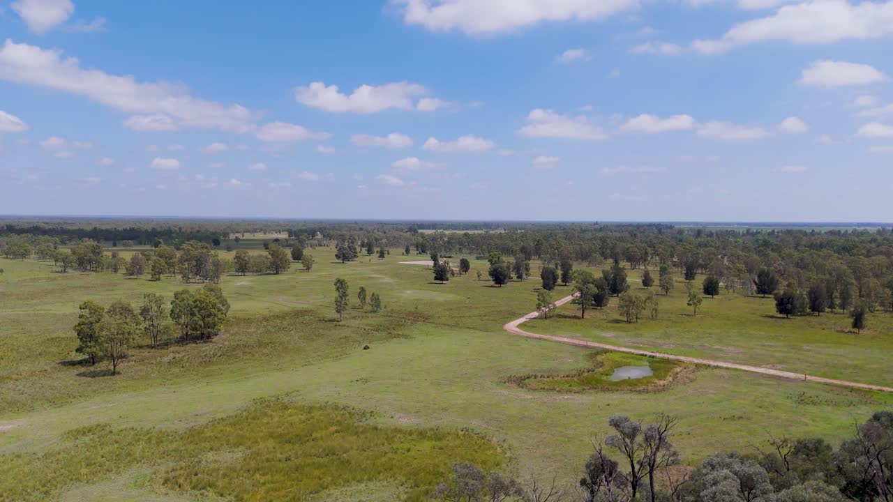 Expansive farmland with dam in dry landscape