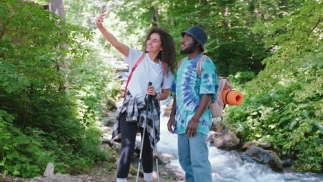 couple taking a selfie in a forest stream