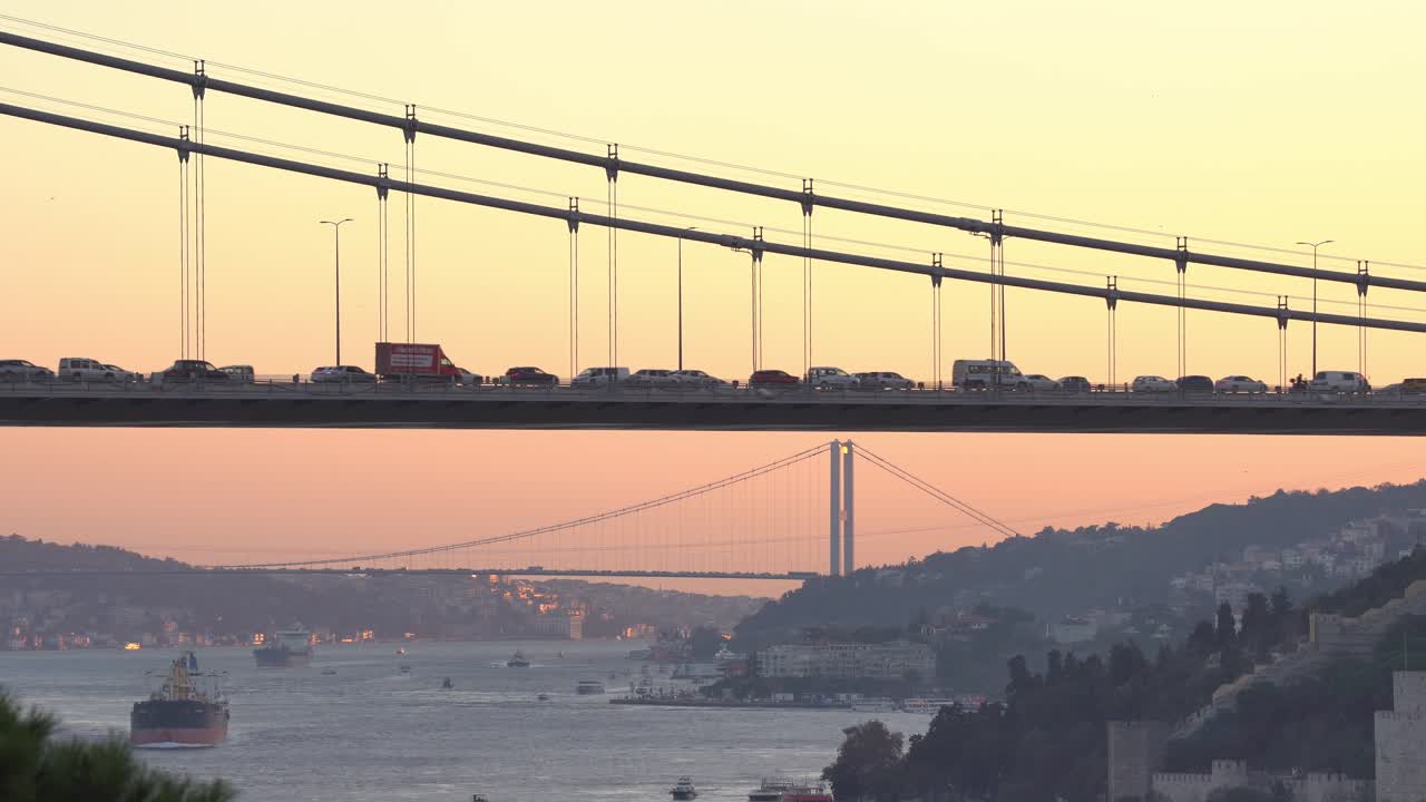 Closeup view of Fatih Sultan Mehmet bridge with Bosphorus Bridge view in the background at sunset