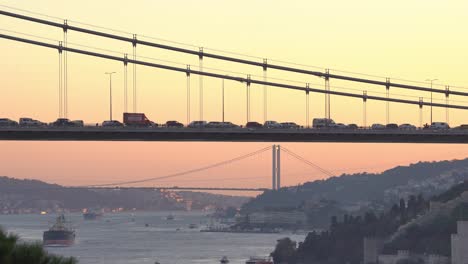 closeup view of fatih sultan mehmet bridge with bosphorus bridge view in the background at sunset
