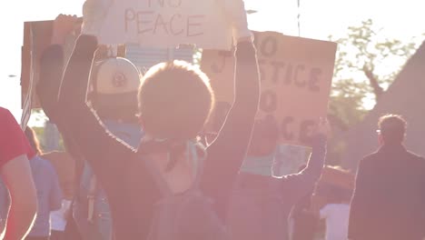 lens flare rim light adds drama to black lives matter protest marchers