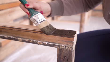painting wood with brown wood paint in slow motion 100fps