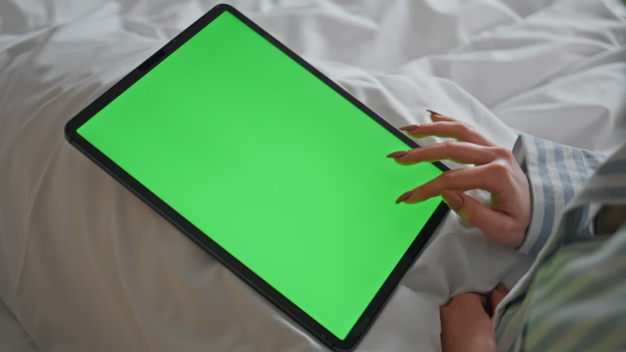 Lady hands touching mockup tablet working home bed closeup. Fingertips tapping