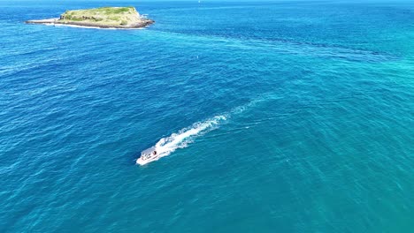 small boat sailing near an island