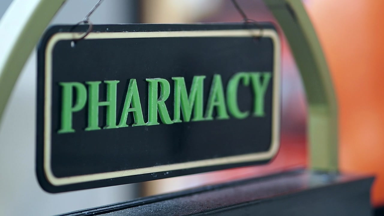 Close-up of a Pharmacy Sign with Green Letters