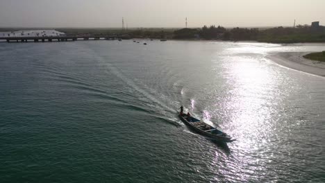 Beautiful-Aerial-Over-Long-Boat-Moving-Along-The-Gambia-River-In-West-Africa-Through-Mangrove-Forests-And-Winding-Bends-3