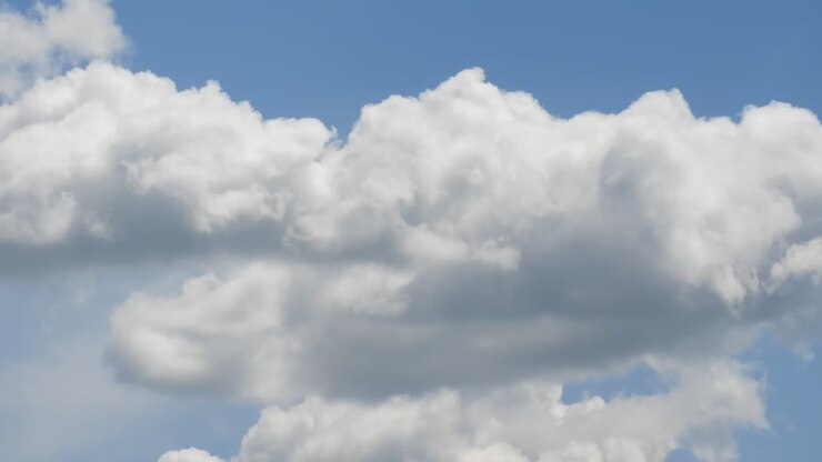 Time lapse with white clouds forming on sunny blue sky