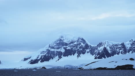 Winter-Mountains-Scenery-in-Snow-and-Ice,-Beautiful-Dramatic-Blue-Landscape-in-Antarctica-on-the-Antarctic-Peninsula,-Cold-Weather-Conditions-with-Big-Mountains