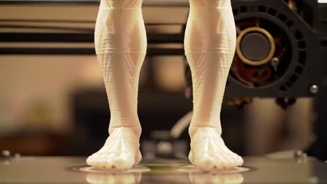 close-up view of 3d printed human legs on a printer bed, showcasing intricate details and high-quality filament patterns in a studio environment