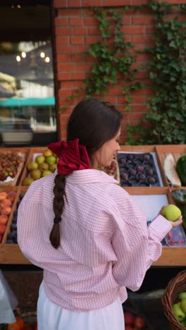 woman shopping for fruit at a farmers market