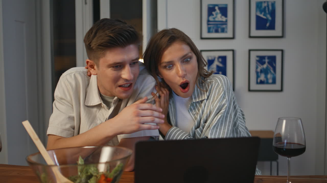Smiling sweethearts watching movie in laptop closeup. Relaxed couple cuddling