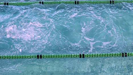 fit woman doing the butterfly stroke in swimming pool