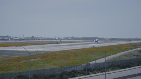 small commercial jet arriving to the airport. aircraft landing on airfield