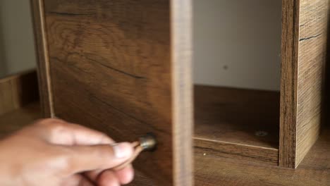 opening a wooden cabinet drawer