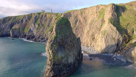 drone panning left around stunning rock formation on the copper coast waterford ireland