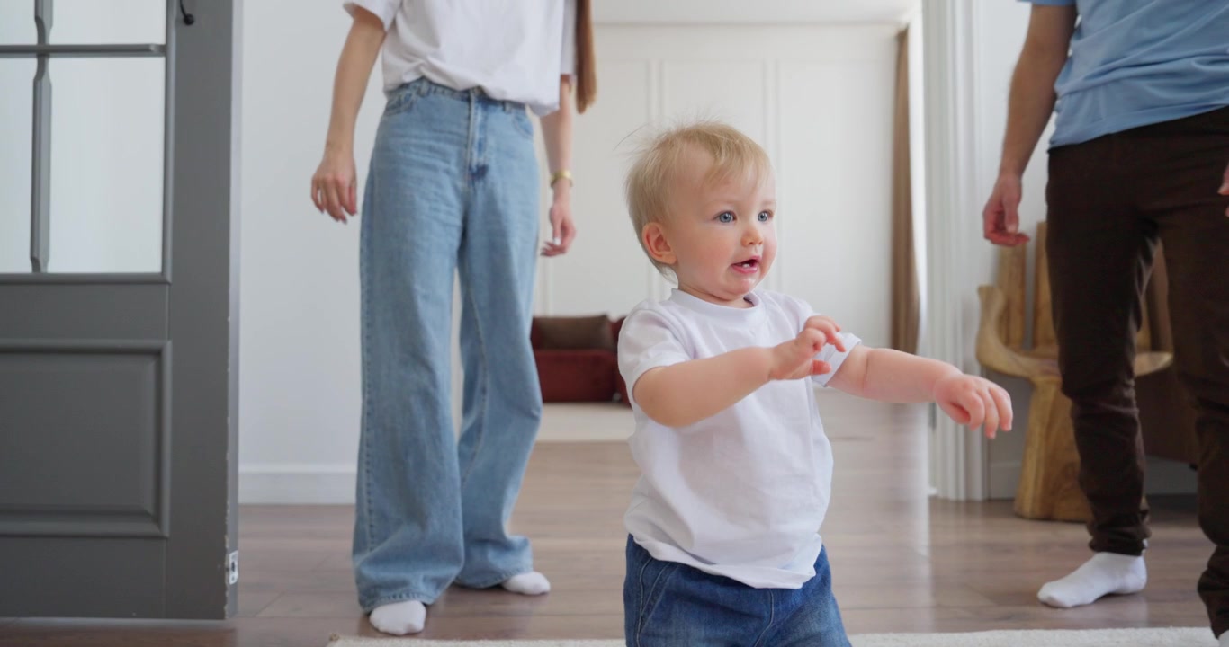 Happy Baby Learning to Walk and Taking First Steps at Home
