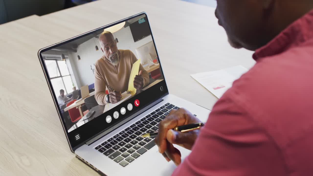 Animation of african american man having video call on laptop