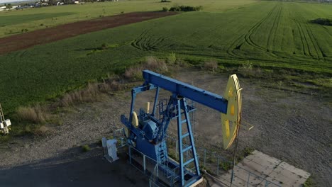 Bomba-De-Aceite-En-Un-Campo-Petrolífero-Trabajando-Y-Bombeando-Petróleo-Crudo-Para-Combustible-Fósil-Con-Plataforma-De-Perforación