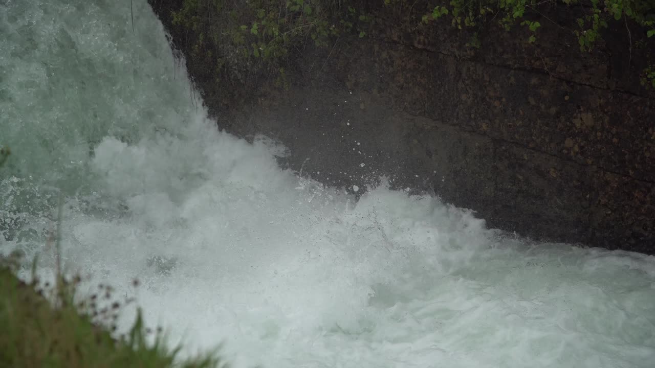 River dam - Flowing and splashing water in cold river.