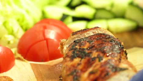 slicing roasted chicken breast meat for vegetable salad toppings while wearing blue rubber gloves - closeup shot