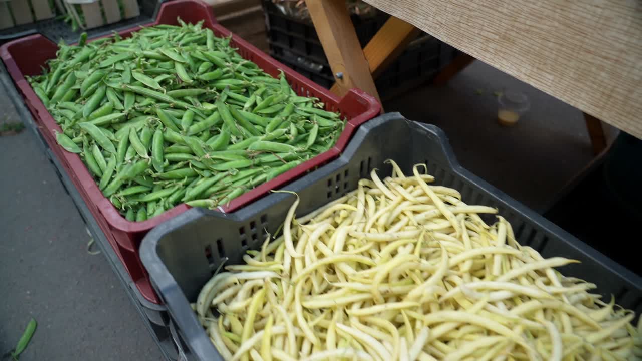 Yellow and green beans displayed in a basket at a market