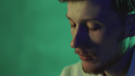 Portrait-of-a-young-man-on-a-neon-light-colorful-background.-Close-up.