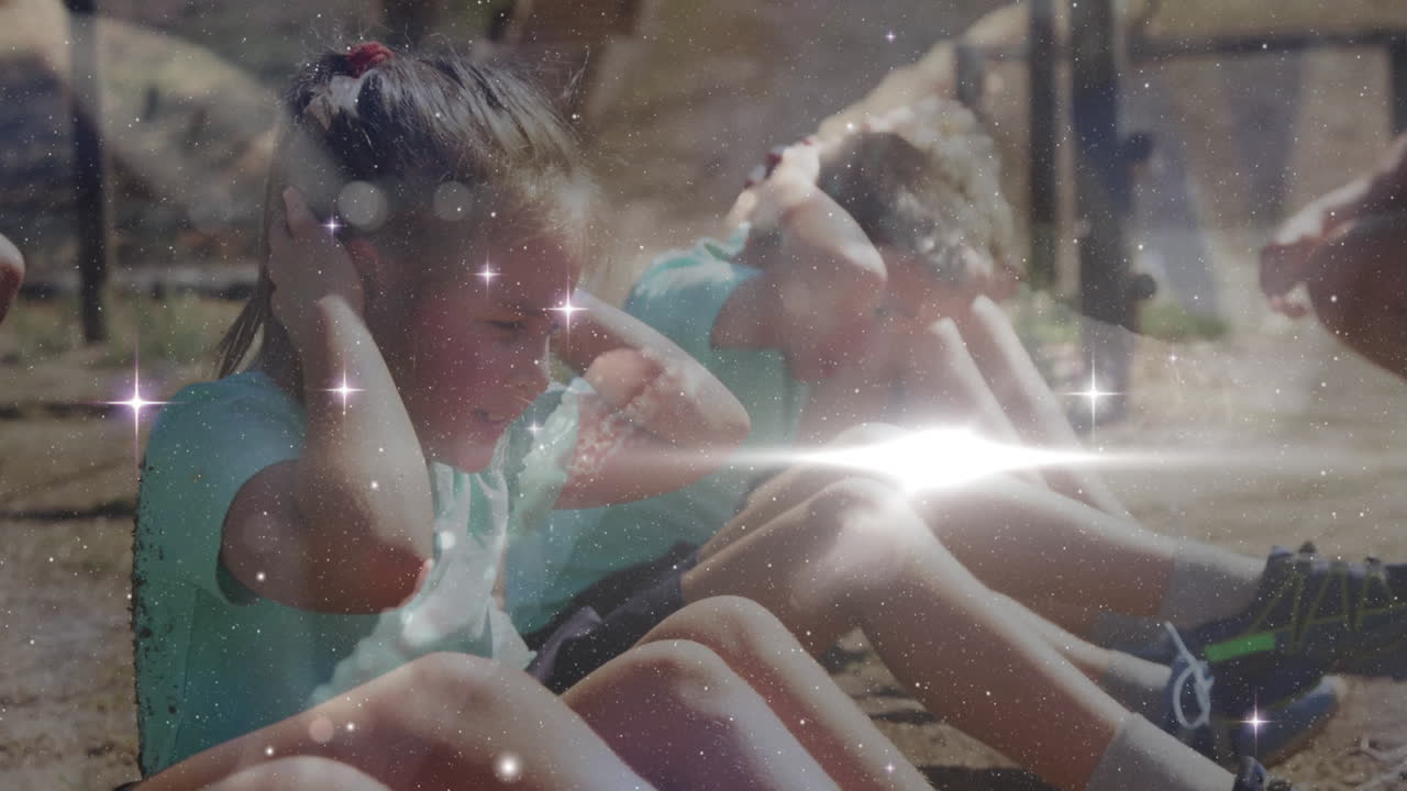 Exercising outdoors, children with sparkling star animation overlay in park