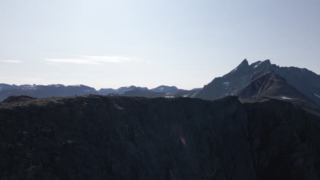 Tourists-At-Romdalseggen-Ridge-With-Rocky-Mountains-In-Background