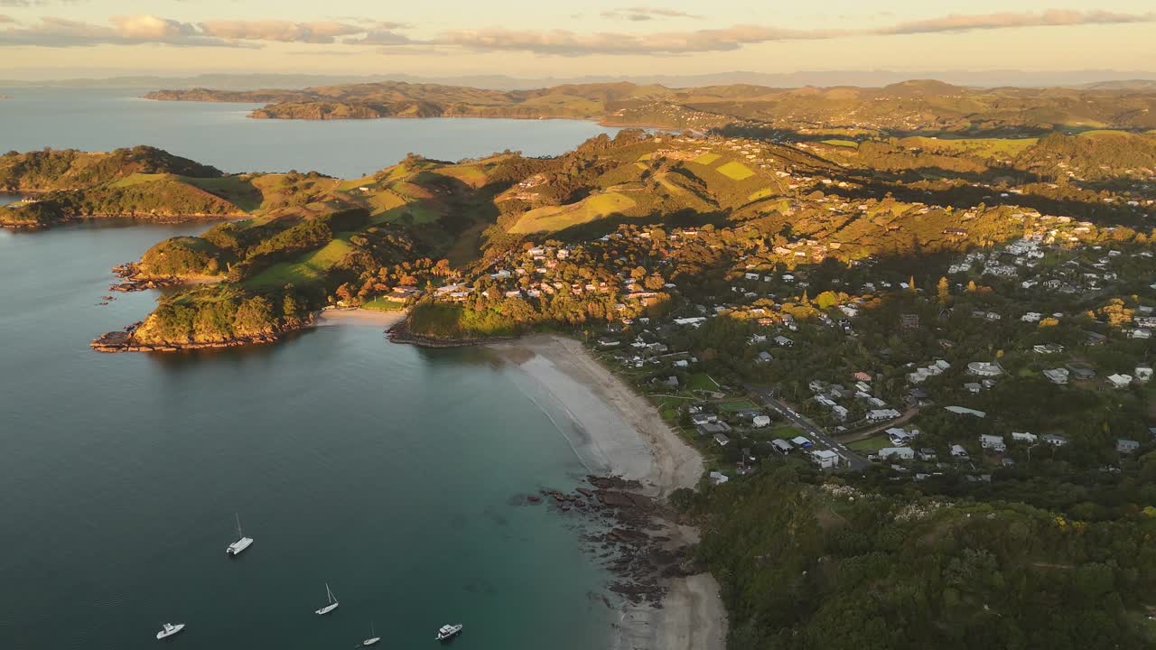 Aerial view of Waiheke Island at sunset over the landscape.