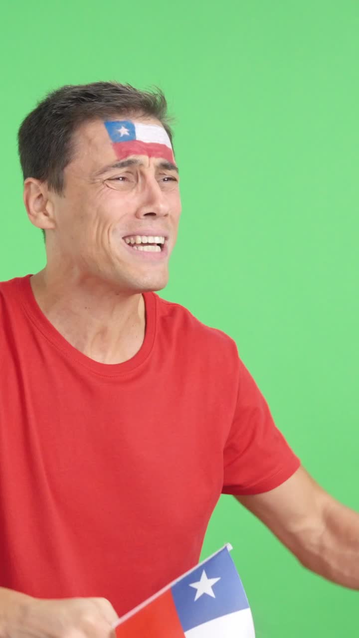 Nervous man cheering for Chile during a match looking away