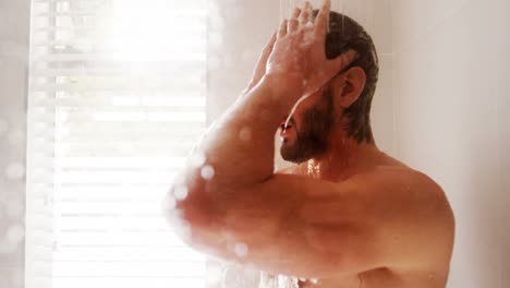 Man-taking-a-shower-in-bathroom