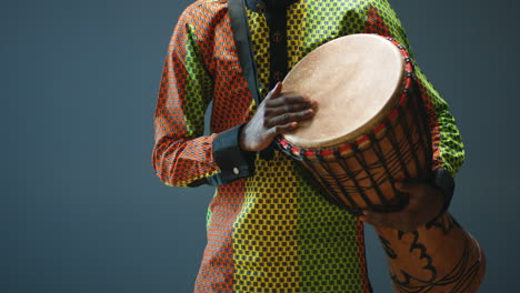 close-up view of young cheerful african american man hands playing a drummer