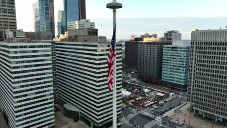 aerial orbit of american flag at rest in usa urban downtown city