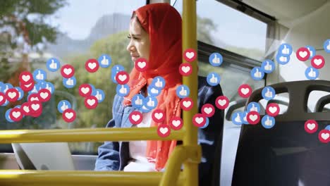 animation of falling social media icons over woman in hijab using laptop