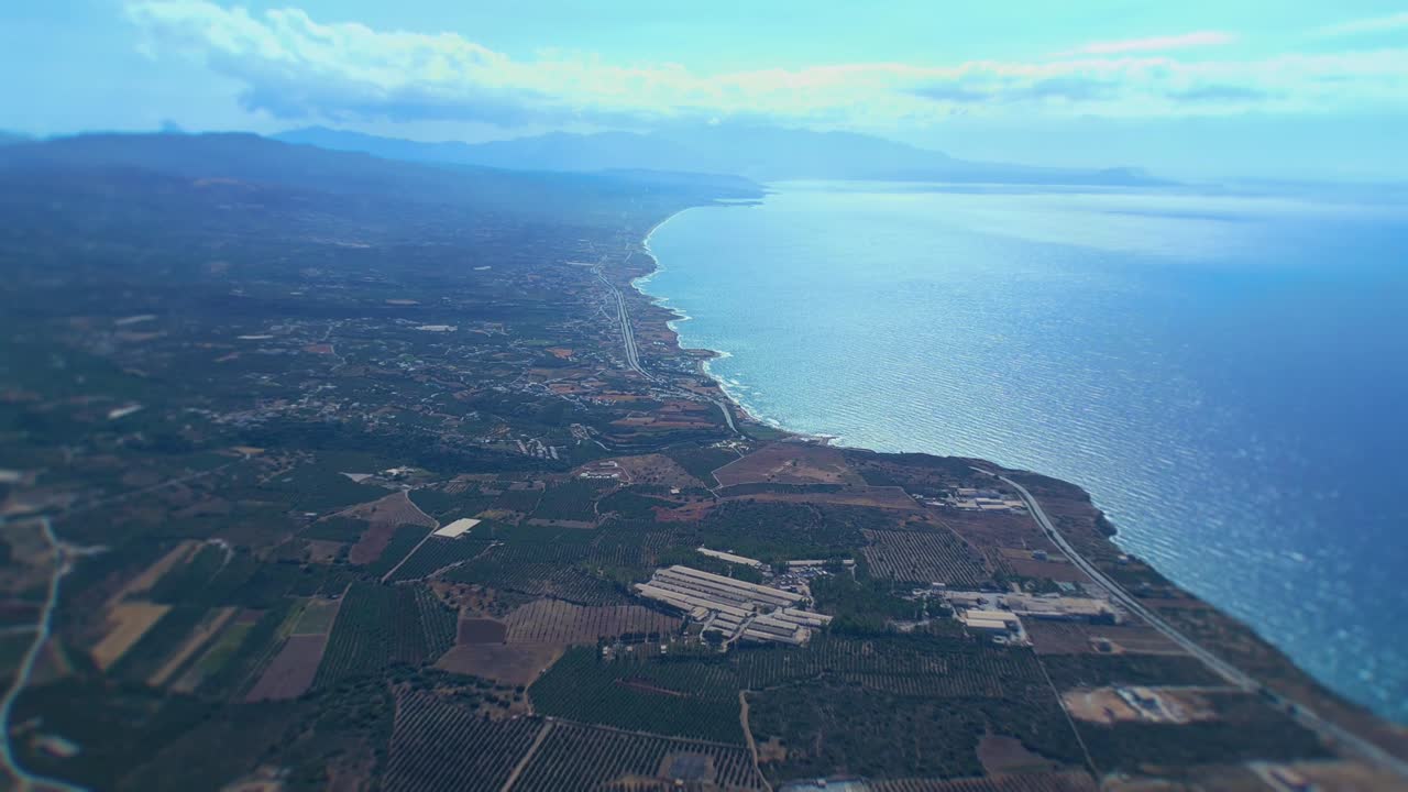 Crete from 500 meters above. stunning contrast between the azure sea and the lush olive gardens