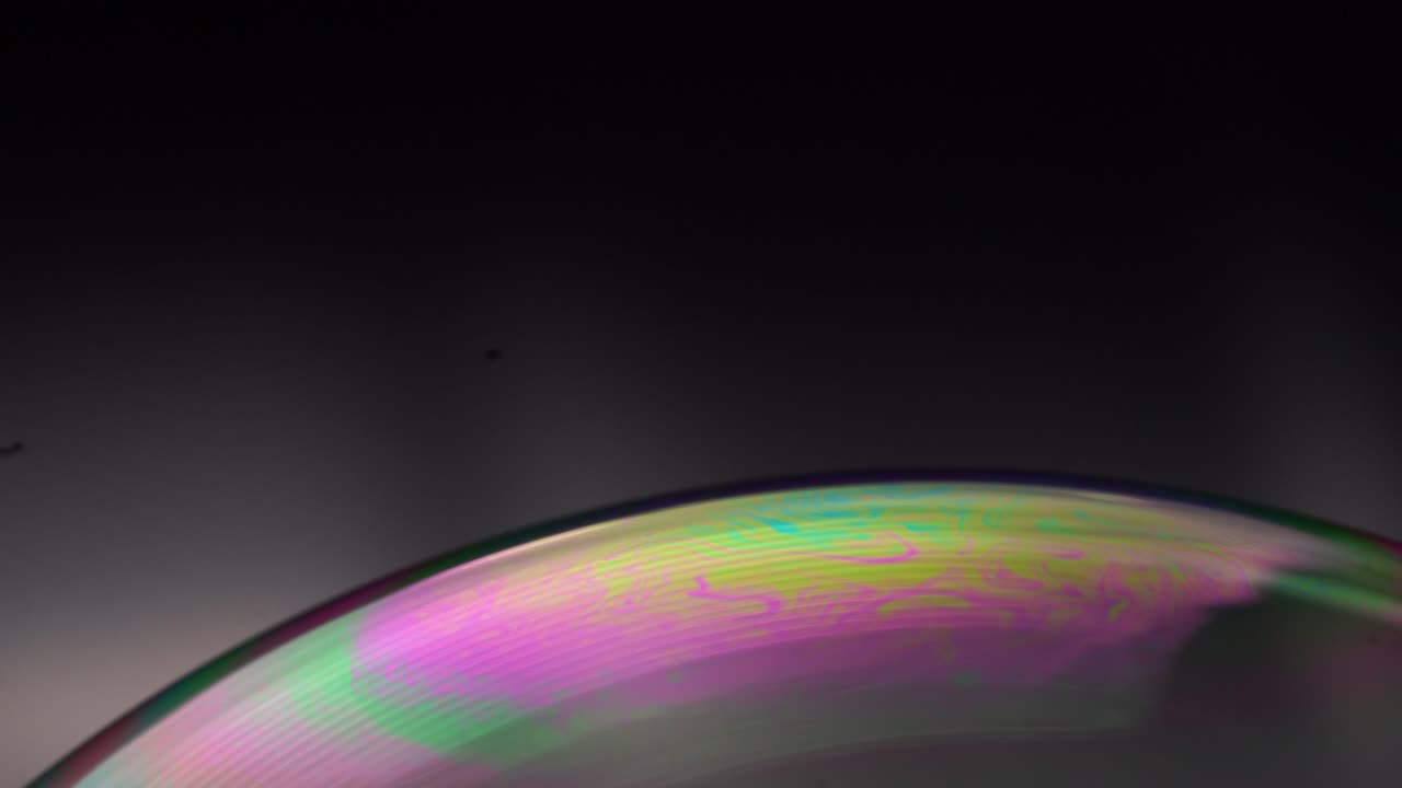 Discover soap bubbles in macro detail, showcasing vivid colors and ethereal formations reminiscent of celestial bodies