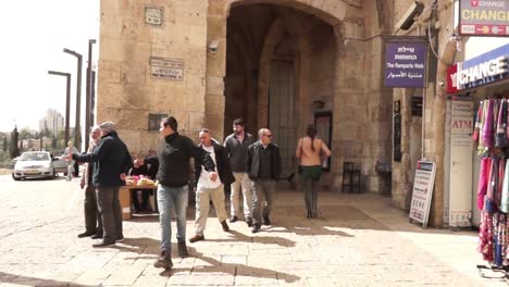 people walking through the old city of jerusalem