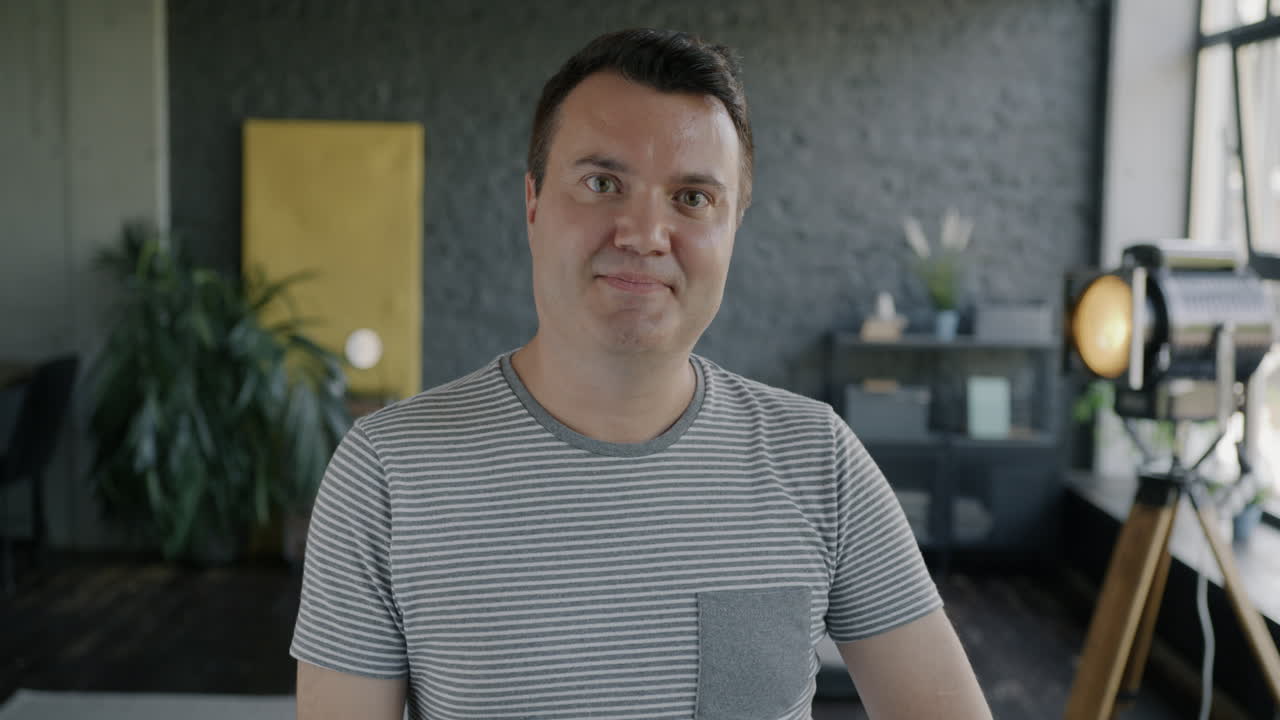 Smiling Man in Office/Home Setting