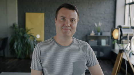 smiling man in office/home setting