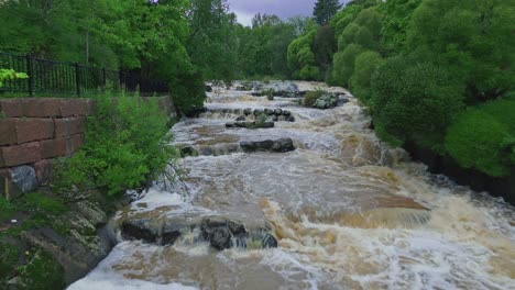 Rapids-surrounded-by-trees-in-Helsinki,-Finland