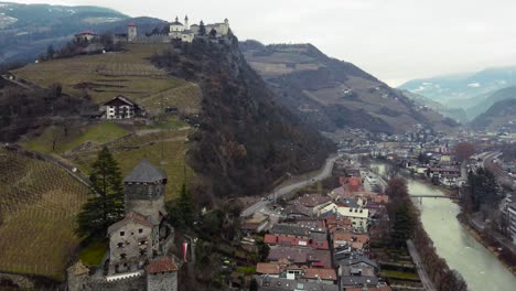 Aerial-over-Chuisa-Old-Town-with-Sabiona-Castle,-South-Tyrol,-Bolzano,-Italy