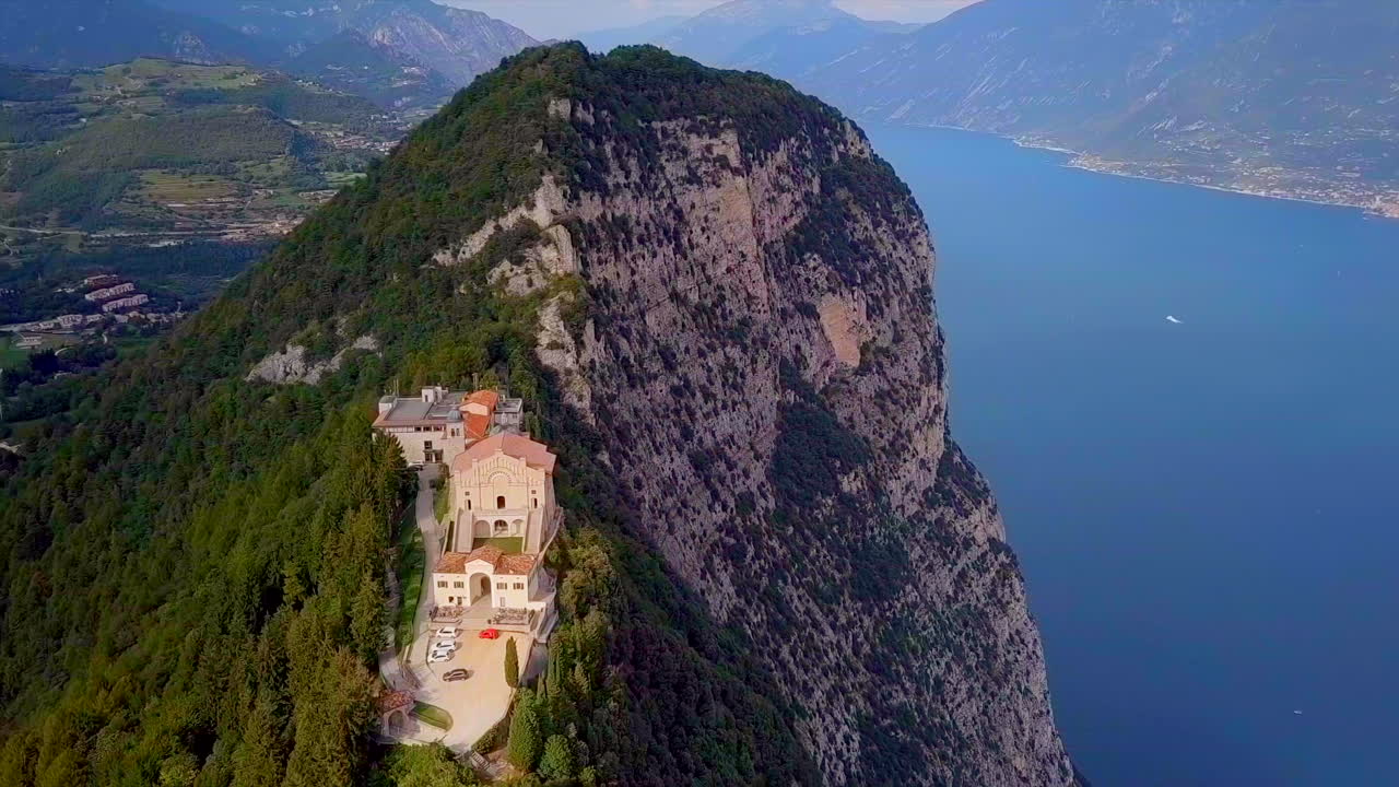 Aerial View of a Church on a Cliffside overlooking a Lake in Italy