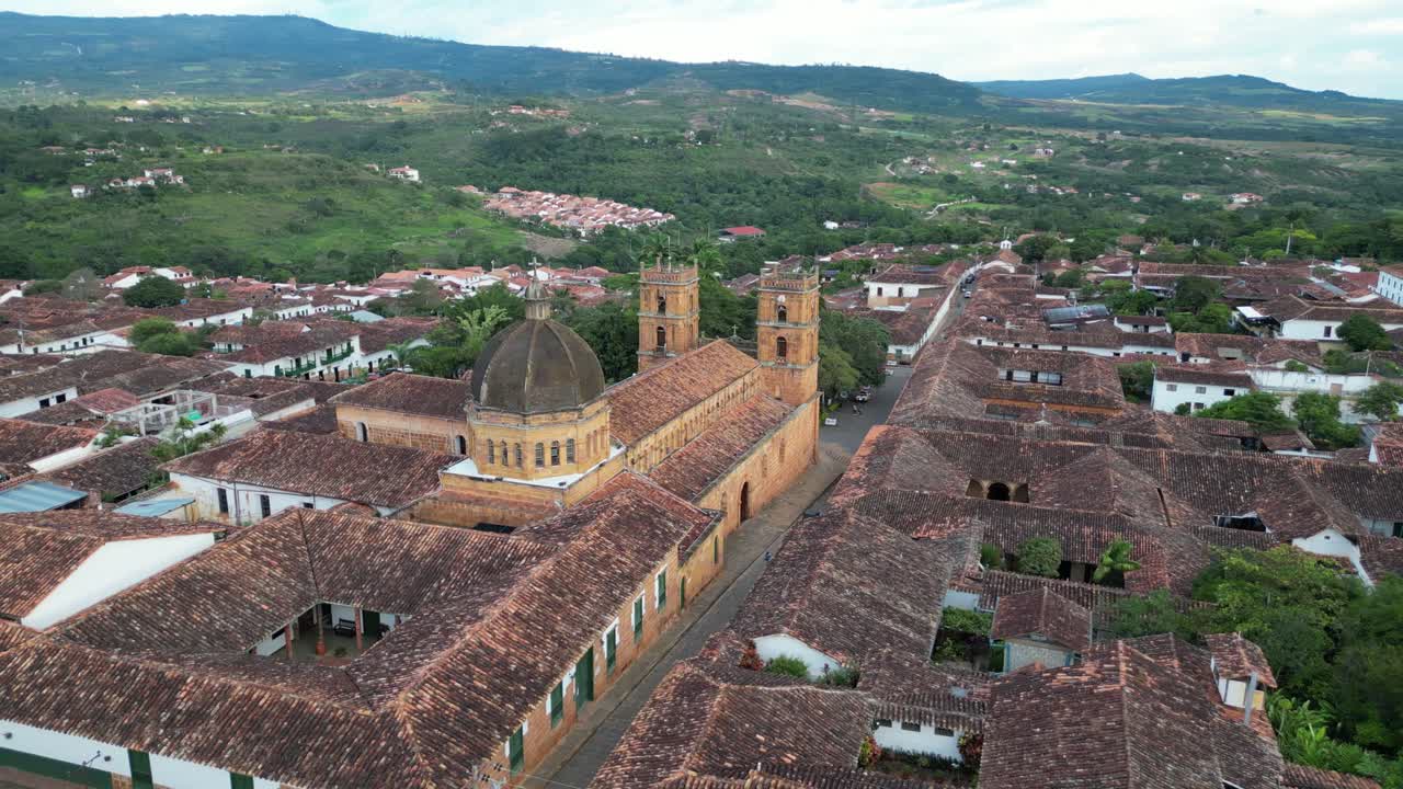 Aerial view of La Inmaculada Concepción church at the central plaza in the picturesque Andean village of Barichara in the Santander Department of Colombia surrounded by green mountains