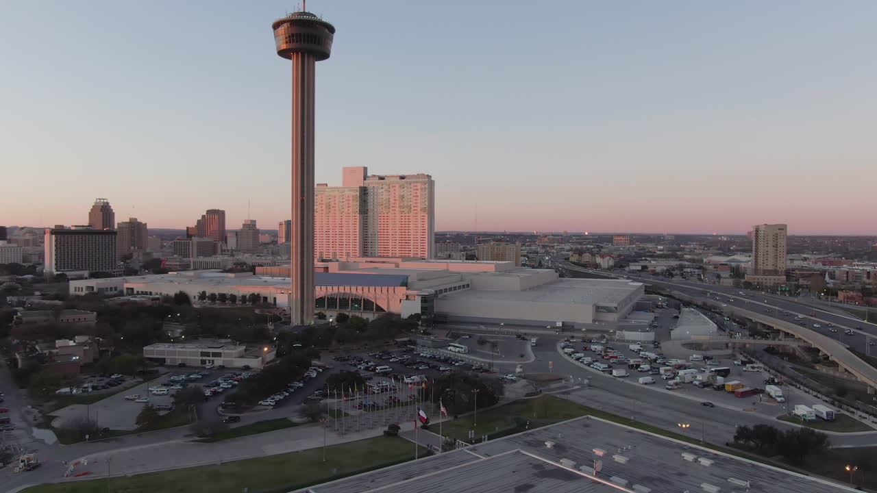 Rising aerial shot of the Tower of the Americas at sunset in San Antonio, Texas.