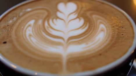 delightful latte art: a close-up view of beautifully crafted coffee with intricate foam designs showcasing the skill of baristas and the richness of espresso based drinks